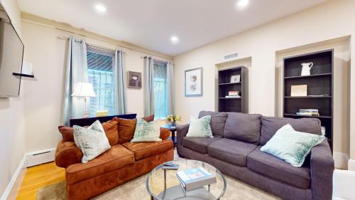 a living room with a couch and a table at Newly Renovated 2-bed, Back Bay Near Mgh, Bu, Mit in Boston