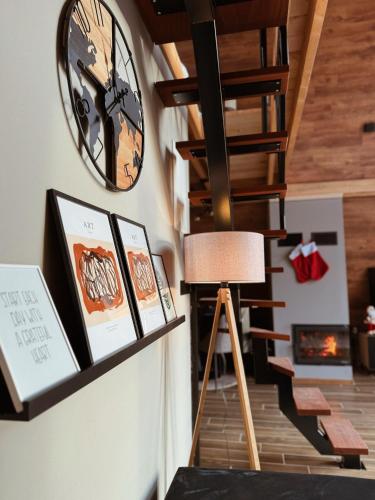 a clock hanging on a wall next to a staircase at Casa Mia Resort in Kupres