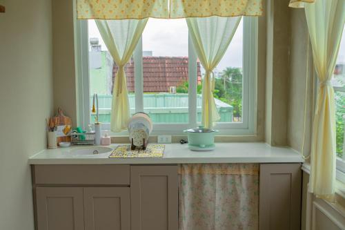 a kitchen with a sink and a window at Camellia Home in Da Nang