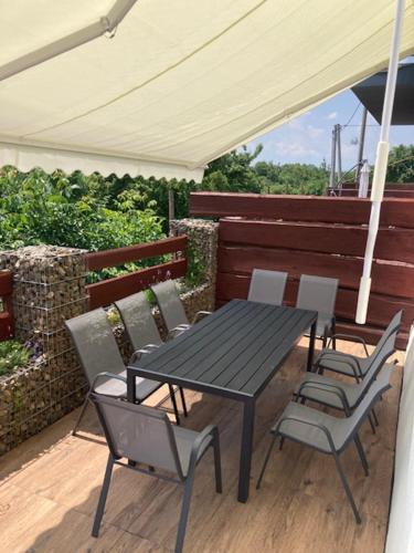 a table and chairs on a deck with an umbrella at chata Viňanka in Michalovce