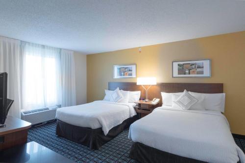 a hotel room with two beds and a television at Fairfield Inn & Suites by Marriott Cleveland Streetsboro in Streetsboro