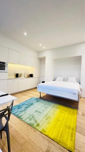 a bedroom with a large bed and a colorful rug at Studio Fischer à la Pétrusse 002 in Luxembourg