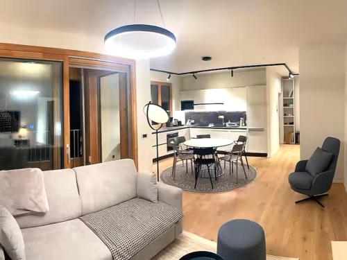 a living room with a white couch and a table at Sonnenalpe Nassfeld Allegra Joy in Sonnenalpe Nassfeld