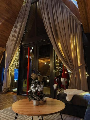 a living room with a table and a couch at Casa Mia Resort in Kupres