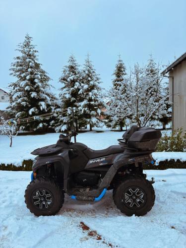 a small quad bike parked in the snow at Casa Mia Resort in Kupres