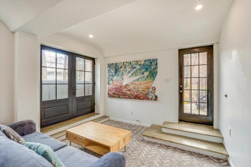 a living room with a couch and a coffee table at Walk to Waterfront Chic Hudson Valley Garden Apt in Kingston