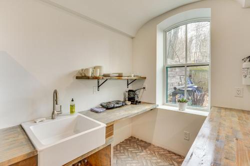 a kitchen with a sink and a window at Walk to Waterfront Chic Hudson Valley Garden Apt in Kingston