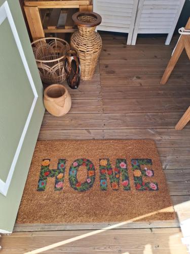 a welcome mat on the floor of a house at Le cocon NéAuNature in Anse-Bertrand
