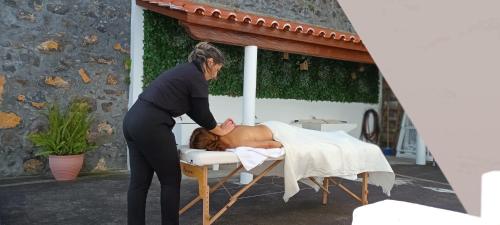 a woman standing next to a man in a bed at Quinta Peixinho RC DT in Horta