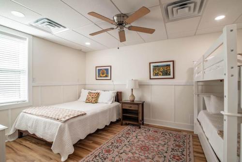 a bedroom with a bed and a ceiling fan at 9 Bedroom Oceanfront Beach House in Debordieu in Pawleys Island