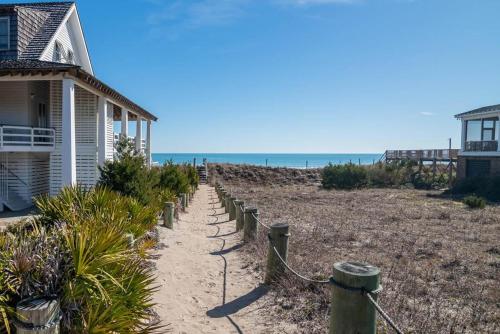 a path leading to a house on the beach at 9 Bedroom Oceanfront Beach House in Debordieu in Pawleys Island