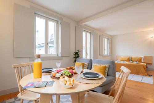 a living room with a table and a couch at Lovely Apartments in the Heart of Guimarães by HostWise in Guimarães