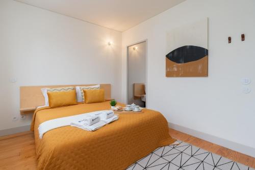 a bedroom with a bed with towels on it at Lovely Apartments in the Heart of Guimarães by HostWise in Guimarães