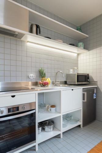 a kitchen with a sink and a counter top at Lovely Apartments in the Heart of Guimarães by HostWise in Guimarães
