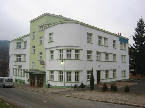 a large white building on the side of a street at Hotel Grand in Tanvald