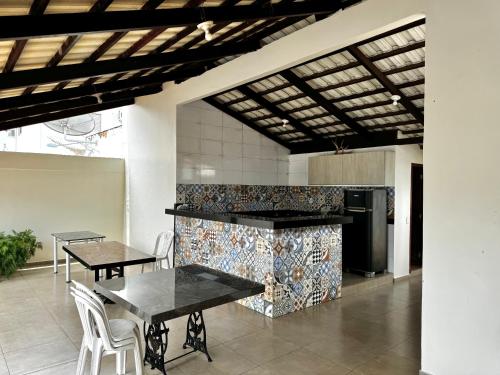 a kitchen with a table and chairs and a stove at Hotel Lunna in Porto Nacional