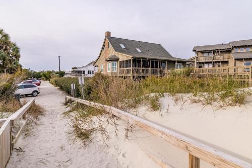 a house on the beach with a car parked in front at Oceanfront Escape with Beach Access in Pawleys Island