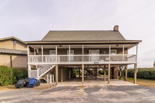 a large house with a wrap around porch at Oceanfront Escape with Beach Access in Pawleys Island