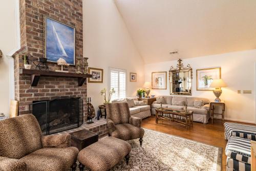 a living room with a fireplace and a couch at Oceanfront Escape with Beach Access in Pawleys Island