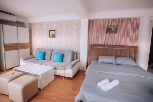 a bedroom with two beds and a couch at Villa Panorama - Lake Side in Ohrid