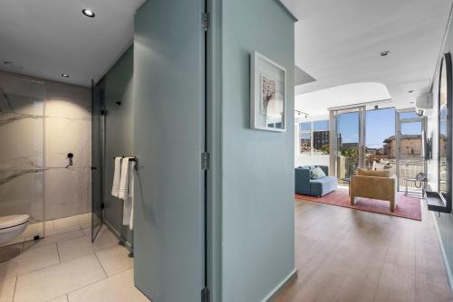 a bathroom with a walk in shower and a toilet at Quarter 411 in Cape Town