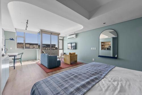 a bedroom with a bed and a table and a desk at Quarter 411 in Cape Town