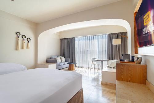 a hotel room with a bed and a desk at Camino Real Acapulco Diamante in Acapulco