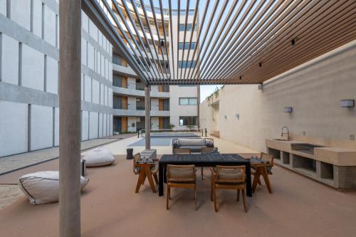 a room with a table and chairs in a building at Punto Nima, Spectacular Pool with Ocean View in San José del Cabo