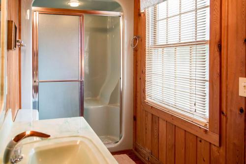 a bathroom with a shower and a sink at Drop Anchor A Dog-Friendly Home with Beach Access in Pawleys Island