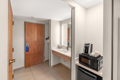 a small bathroom with a sink and a microwave at Holiday Inn Express & Suites Hayward by IHG in Hayward