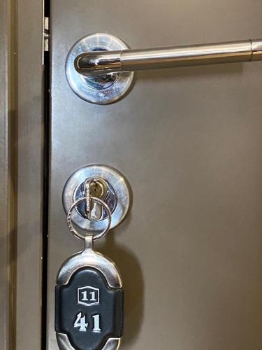 a metal door with a lock on it at LaKop Apartman in Kopaonik