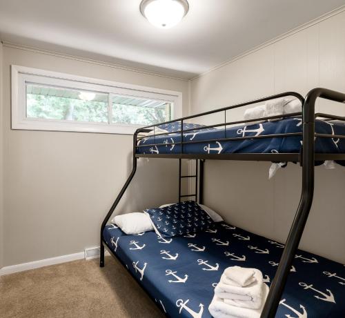 a bedroom with a bunk bed and a window at Dunes Edge- Private Silver Lake Home in Mears
