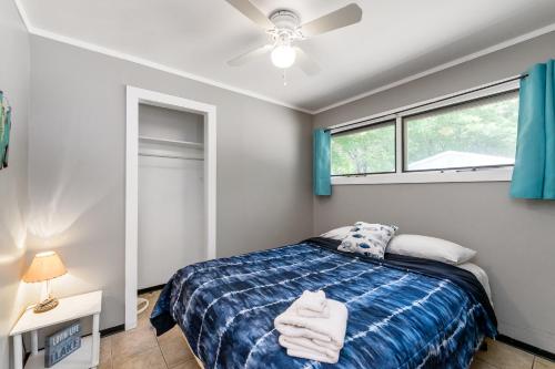 a bedroom with a bed and a window at Dunes Edge- Private Silver Lake Home in Mears