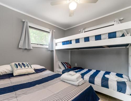 a bedroom with two bunk beds and a window at Dunes Edge- Private Silver Lake Home in Mears