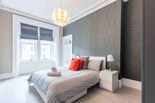 a bedroom with a large bed and a window at Spacious 3 bed home in Marchmont in Edinburgh