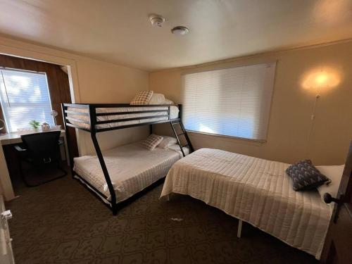 a bedroom with two bunk beds and a window at Cozy Gem King Bunk Beds Near Major Highways Sleep6 in Lincoln Park