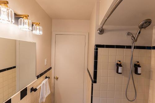 a bathroom with a shower and a shower head at 4 Bedroom 2 and a half bath that Sleeps 8 Near it all Ford Telegraph in Dearborn
