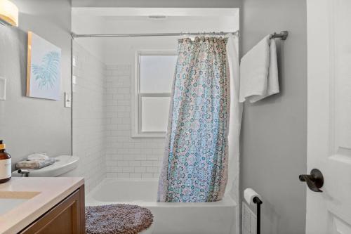 a bathroom with a shower with a shower curtain at 3 Bedroom Fenced Backyard Pets Welcome Sleeps 6 in Lincoln Park