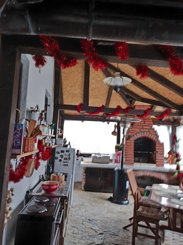 a kitchen with a table and a fireplace in a room at Konak Lecic in TrÅ¡iÄ‡