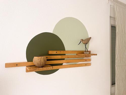 a bird sitting on a wooden shelf on a wall at BENAMAR HOUSE in Quarteira