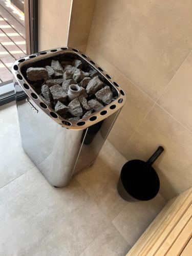 a bin of rocks in a corner of a room at Chata pod Ostrým vrchom in Soblahov