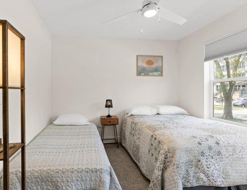 a bedroom with two beds and a window at Silverside House - Pet Friendly - Centrally Located in Muskegon