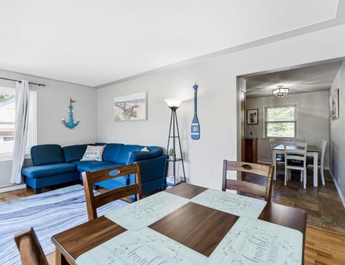 a living room with a blue couch and a table at Private pool, close to Lake Michigan Beaches in Muskegon