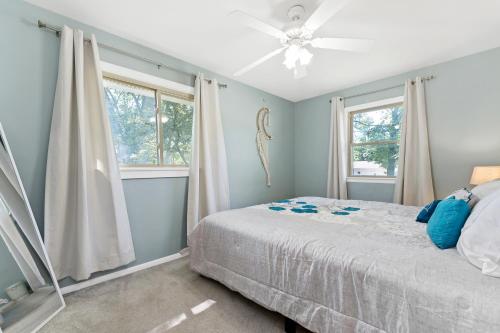 a bedroom with a bed and two windows at Private pool, close to Lake Michigan Beaches in Muskegon