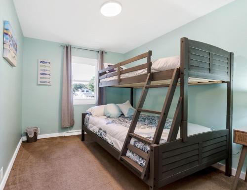 a bedroom with two bunk beds and a window at Private pool, close to Lake Michigan Beaches in Muskegon