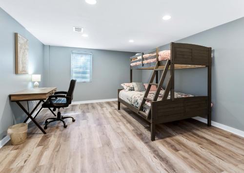 a bedroom with a desk and a bunk bed at Private pool, close to Lake Michigan Beaches in Muskegon