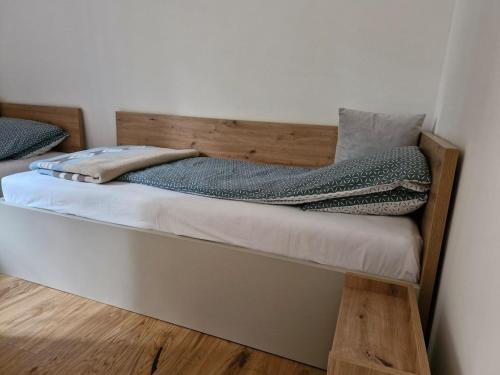 a bed with a woodeninylinylinylinylinylinylinyl at Green peace-Bjelašnica in SJJ