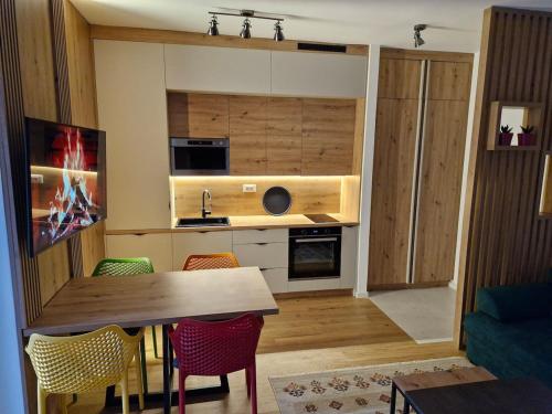 a kitchen with a table and chairs in a room at Green peace-Bjelašnica in SJJ