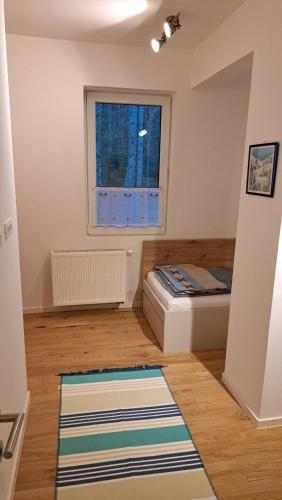 a small bedroom with a bed and a window at Green peace-Bjelašnica in SJJ