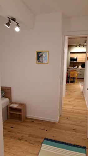 a living room with white walls and a wooden floor at Green peace-Bjelašnica in SJJ